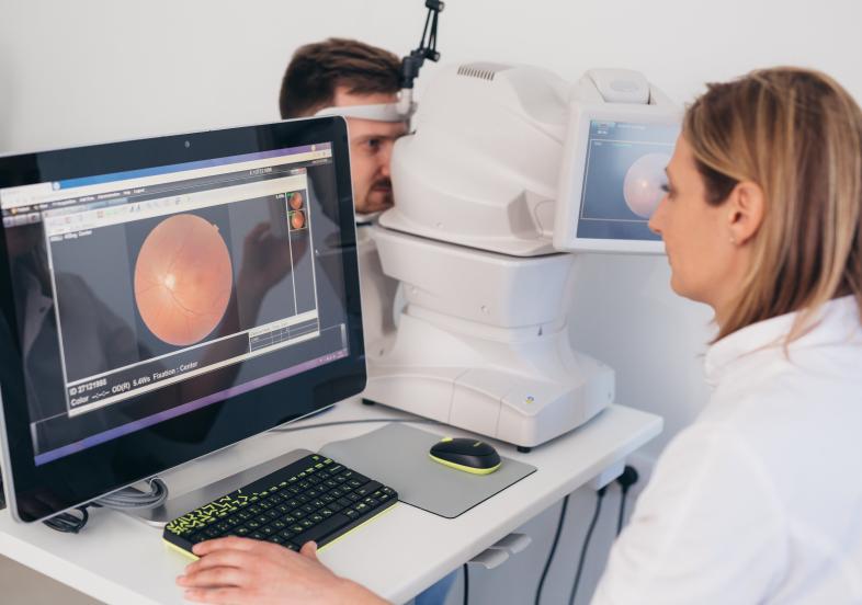 Optometrist performing retinal imaging