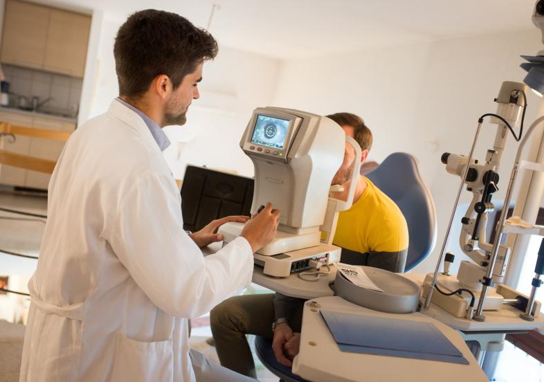 Optometrist performing exam on patient