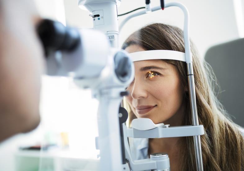 Woman receiving an eye exam with an optometrist