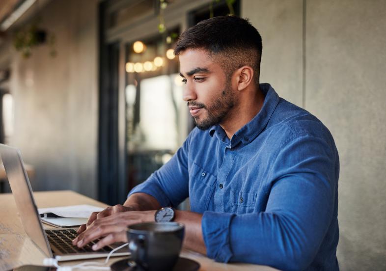 Male worker typing on laptop