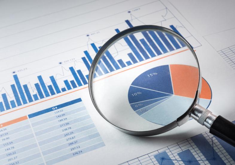 Magnifying glass over various types of graphs. 